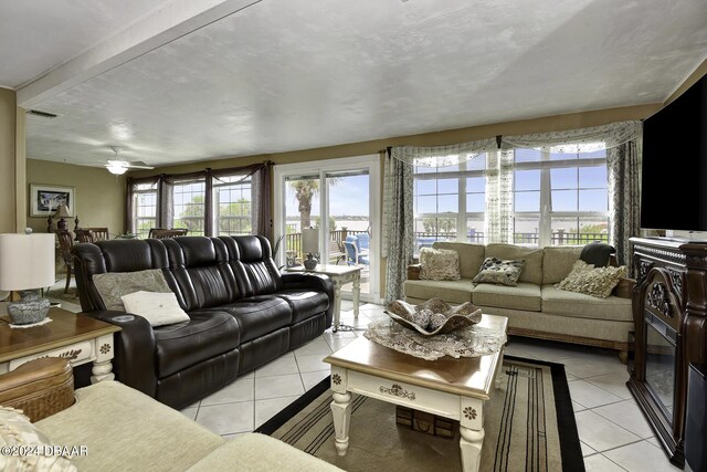 1199 N Halifax Ave, Daytona Beach, FL 32118 - living area featuring light tile patterned flooring, plenty of natural light, and a ceiling fan
