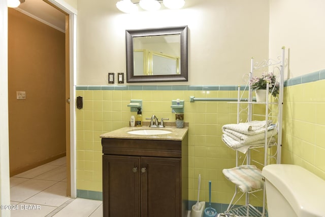 1199 N Halifax Ave, Daytona Beach, FL 32118 - bathroom with tile walls, tile patterned floors, vanity, and wainscoting