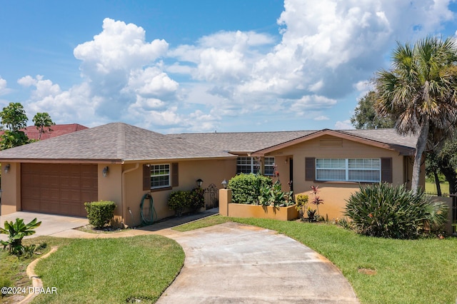 single story home with a front lawn and a garage