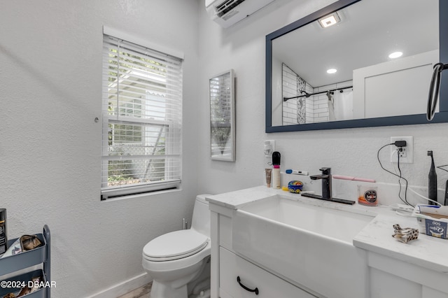 bathroom featuring walk in shower, vanity, and toilet