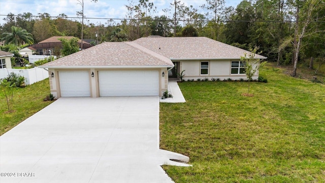 ranch-style house featuring a front yard and a garage