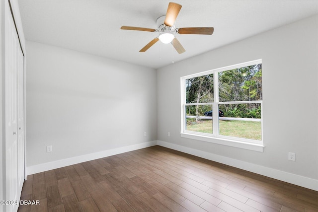 spare room with ceiling fan and wood-type flooring