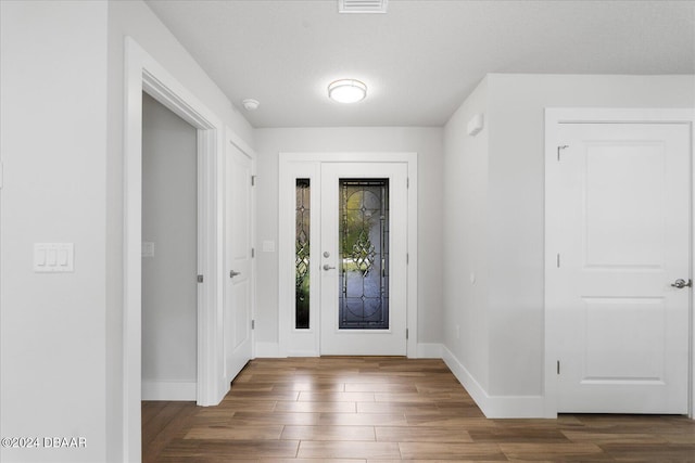 entrance foyer featuring dark hardwood / wood-style flooring and a textured ceiling