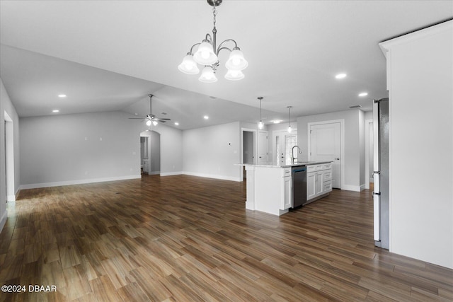 kitchen featuring dark hardwood / wood-style flooring, hanging light fixtures, a center island with sink, and appliances with stainless steel finishes