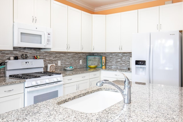 kitchen featuring crown molding, sink, white appliances, and white cabinets