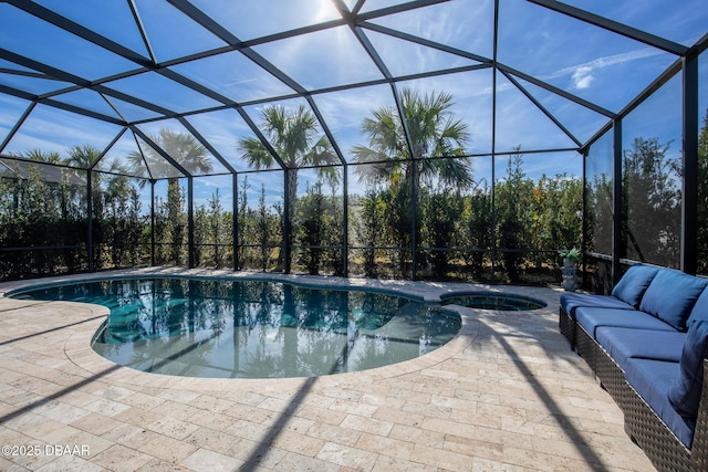 view of swimming pool featuring a patio, an in ground hot tub, and glass enclosure