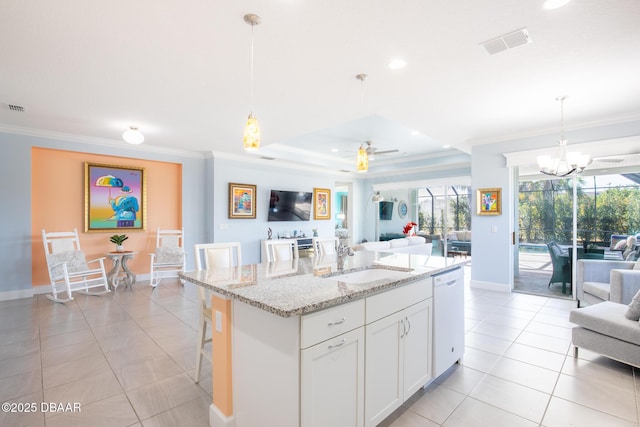 kitchen featuring sink, a breakfast bar, white cabinetry, white dishwasher, and decorative light fixtures