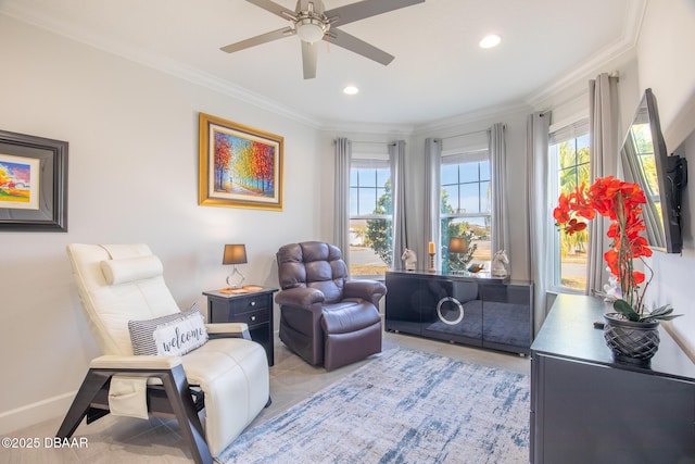 sitting room with crown molding and ceiling fan