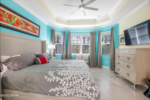 tiled bedroom with a raised ceiling, ornamental molding, and ceiling fan