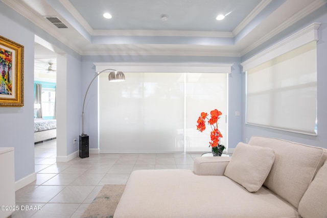 tiled bedroom with crown molding and a tray ceiling