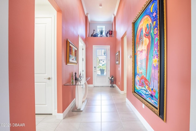 hall featuring crown molding and light tile patterned floors