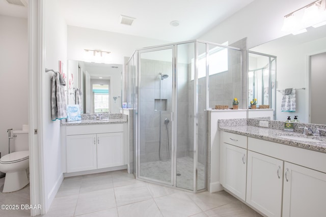 bathroom featuring vanity, an enclosed shower, tile patterned floors, and toilet