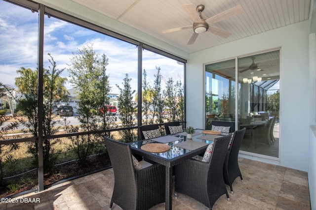 sunroom / solarium featuring ceiling fan