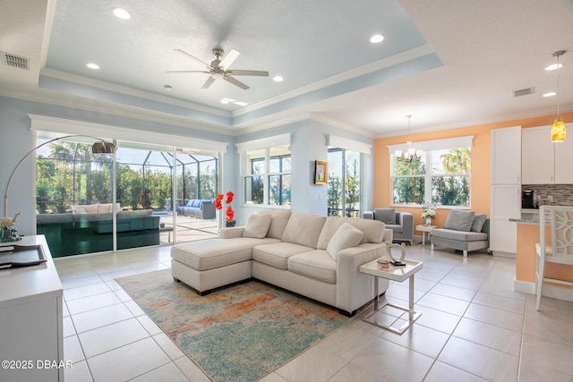 living room featuring a raised ceiling, light tile patterned flooring, and crown molding