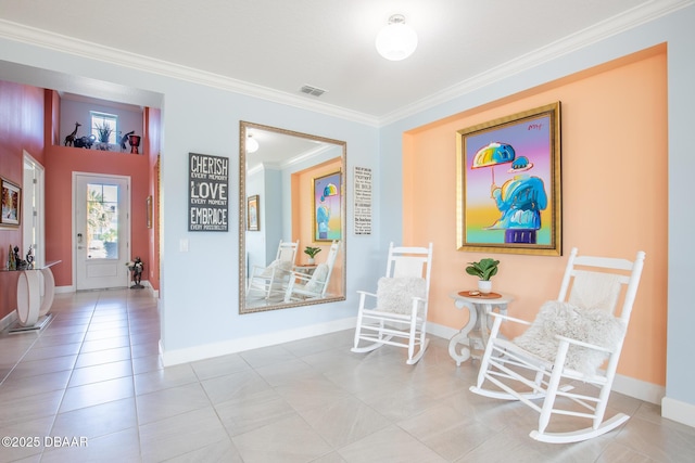 sitting room with ornamental molding and light tile patterned floors