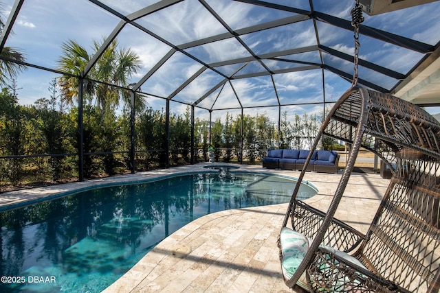 view of swimming pool featuring a lanai, outdoor lounge area, and a patio area