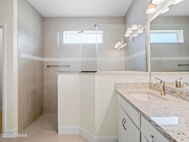 bathroom with vanity, tile patterned floors, and a tile shower