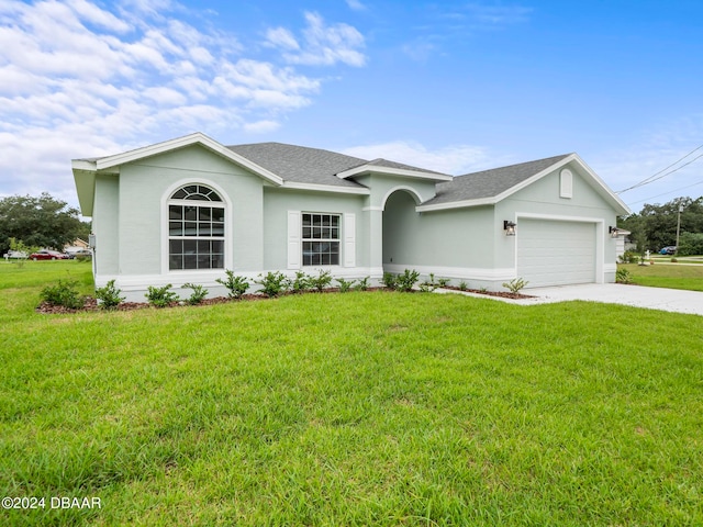 single story home with a garage and a front lawn