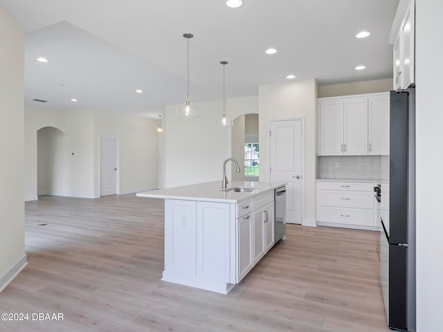 kitchen featuring white cabinetry, sink, and a center island with sink