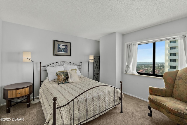 carpeted bedroom with a textured ceiling and baseboards