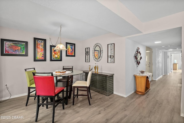 dining area featuring wood finished floors and baseboards