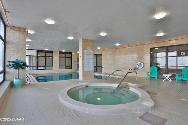 view of swimming pool featuring an indoor hot tub