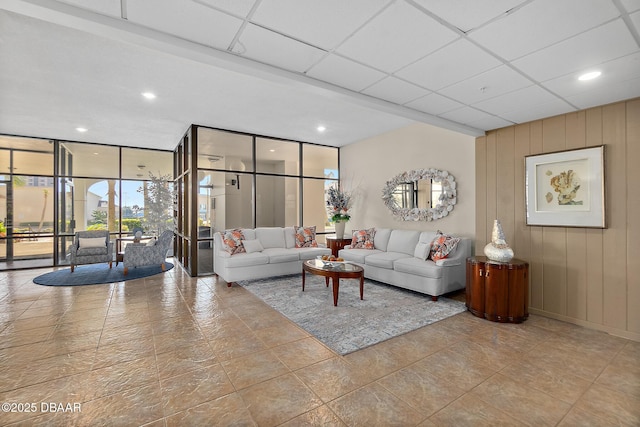 living room with expansive windows, a paneled ceiling, and recessed lighting