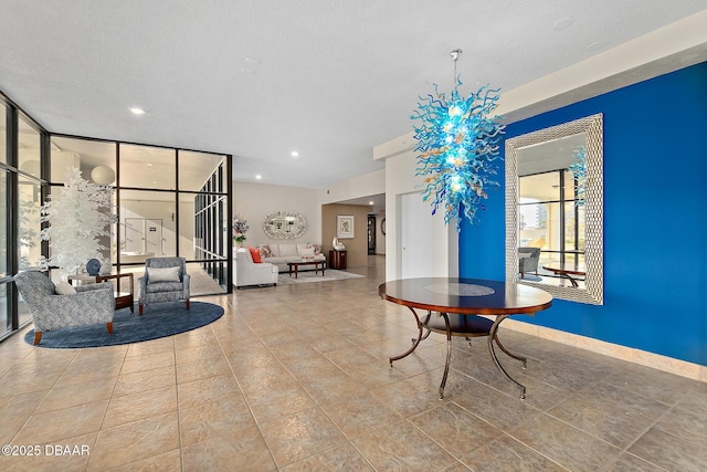 interior space with baseboards, a wall of windows, a textured ceiling, and recessed lighting