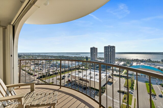 balcony with a water view and a city view