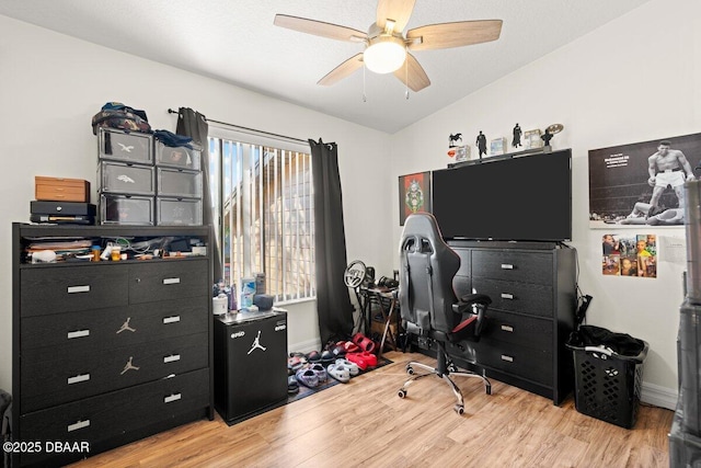 office featuring lofted ceiling, light hardwood / wood-style floors, and ceiling fan