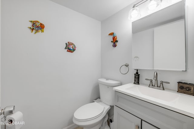 half bath featuring toilet and vanity
