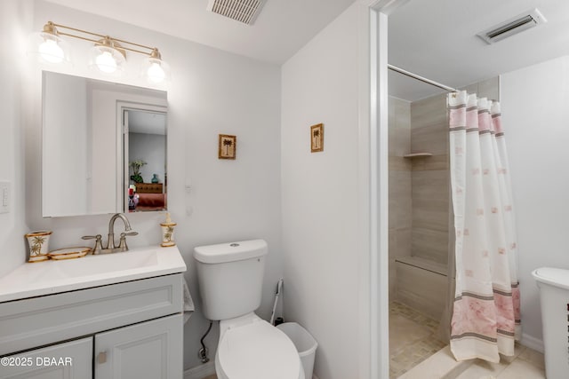 bathroom with visible vents, toilet, tiled shower, and vanity