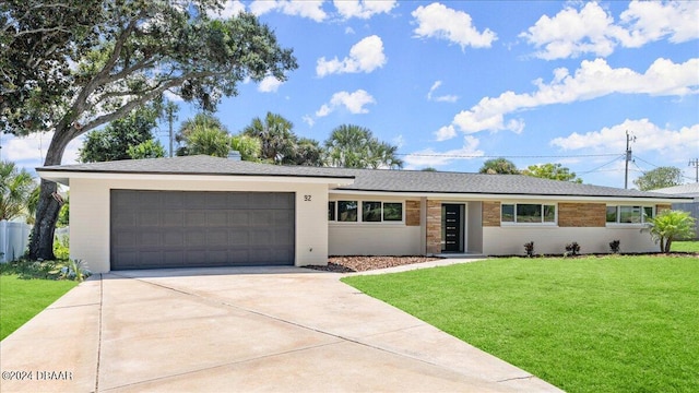 ranch-style home featuring a front yard and a garage