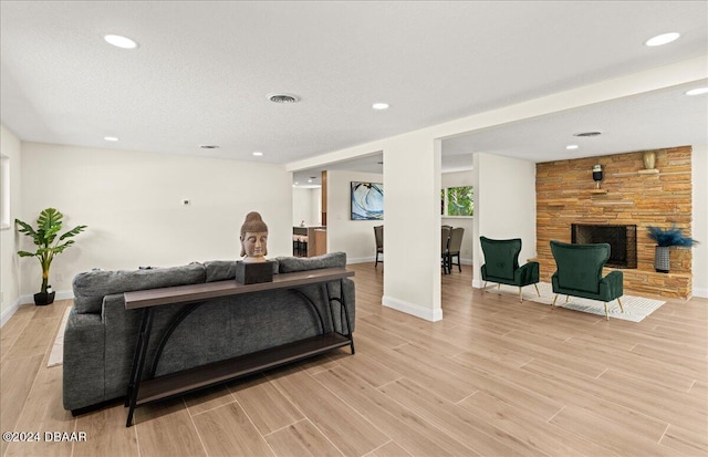 living room featuring light hardwood / wood-style floors and a fireplace