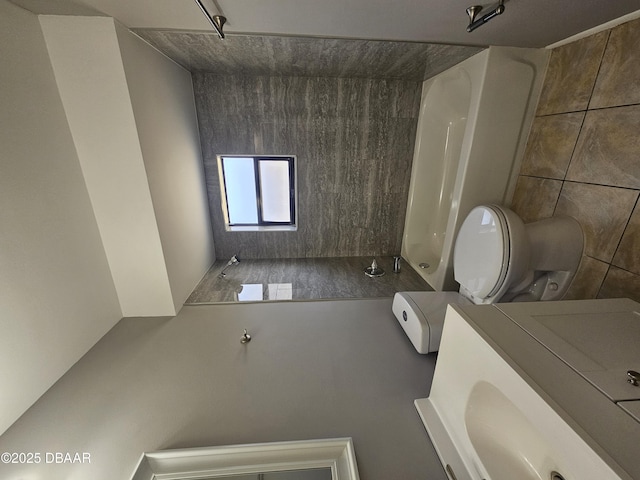 bathroom featuring toilet, tile walls, and walk in shower