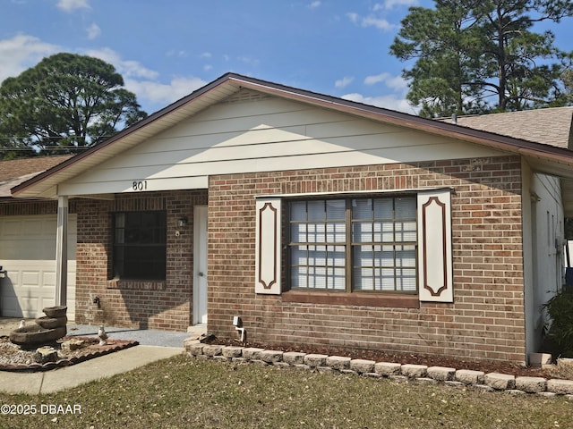 ranch-style house featuring brick siding and a garage