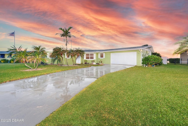 view of front of home featuring a garage and a yard