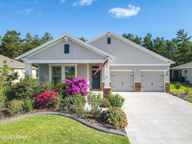 view of front of house featuring a front yard and a garage