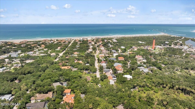 drone / aerial view featuring a beach view and a water view