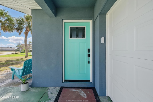 8 Camellia Dr, Ormond Beach, FL 32176 - view of exterior entry featuring stucco siding