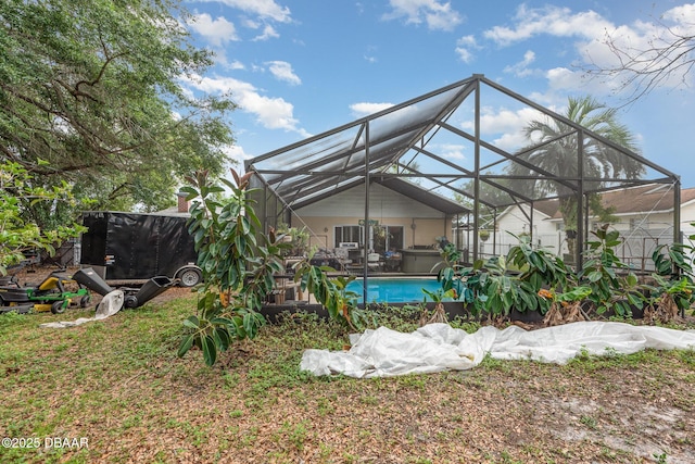 exterior space with a hot tub, an outdoor pool, and a lanai