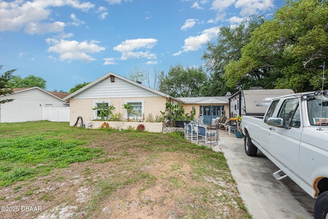 ranch-style home with a patio, fence, and a front yard