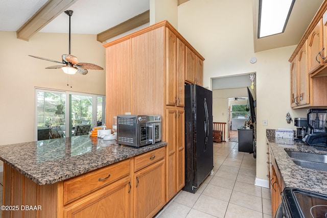 kitchen with a ceiling fan, electric range, high vaulted ceiling, freestanding refrigerator, and light tile patterned flooring