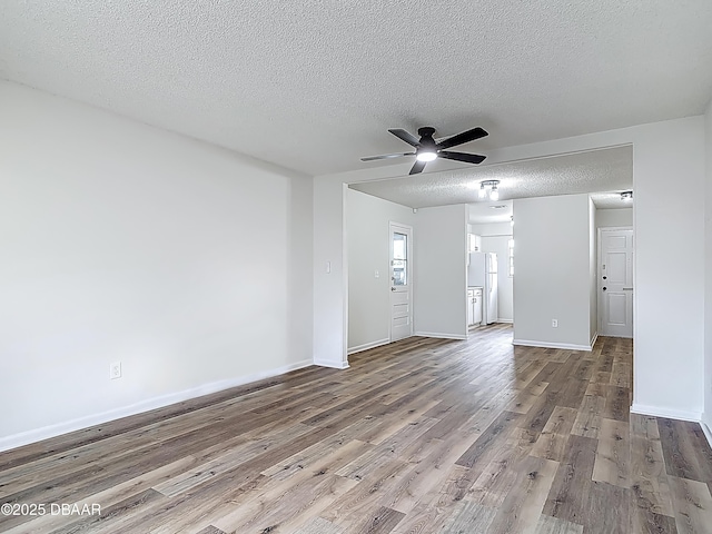 244 Oakleigh Dr, Deland, FL 32724 - unfurnished living room with a textured ceiling, wood finished floors, a ceiling fan, and baseboards
