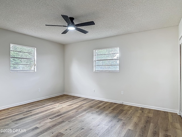 244 Oakleigh Dr, Deland, FL 32724 - spare room featuring wood finished floors, a textured ceiling, a ceiling fan, and baseboards