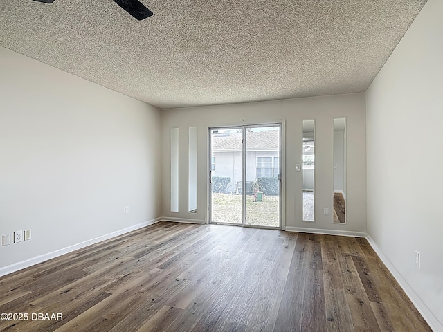 244 Oakleigh Dr, Deland, FL 32724 - empty room with dark wood finished floors, a textured ceiling, and baseboards