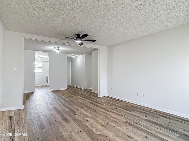 244 Oakleigh Dr, Deland, FL 32724 - unfurnished room with wood finished floors, ceiling fan, a textured ceiling, and baseboards