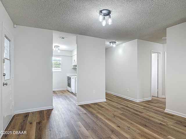 244 Oakleigh Dr, Deland, FL 32724 - spare room with wood finished floors, a textured ceiling, and baseboards