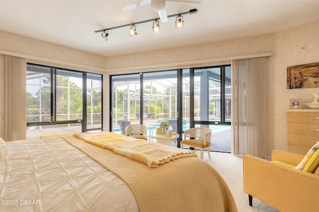 bedroom with multiple windows, access to exterior, carpet flooring, and a sunroom