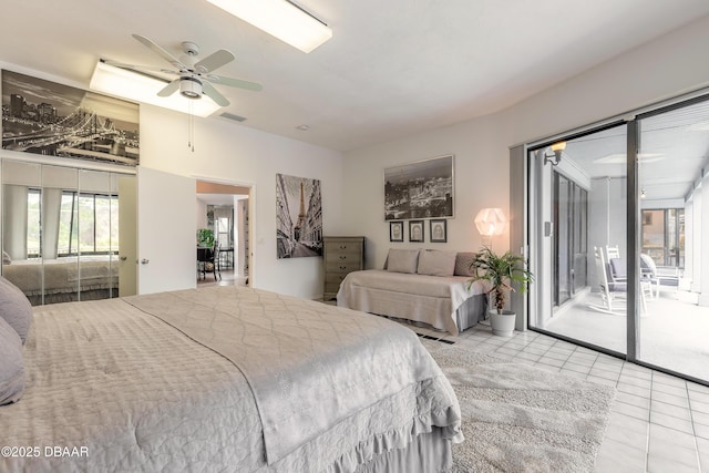 bedroom featuring tile patterned flooring, visible vents, multiple windows, and access to outside